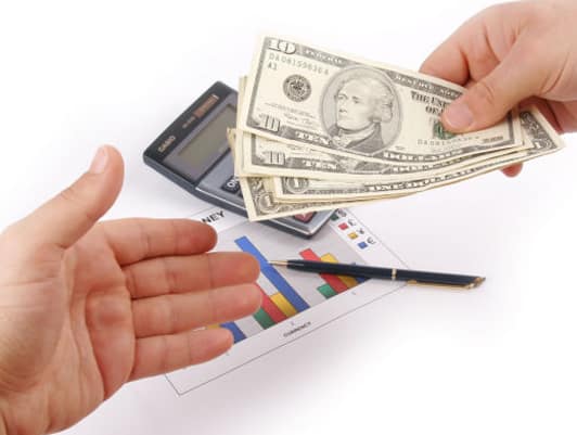 Man Handing Over Money to Another Person