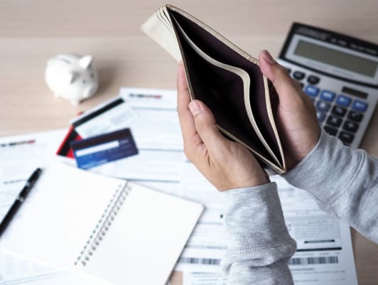 Man Holding an Empty Wallet