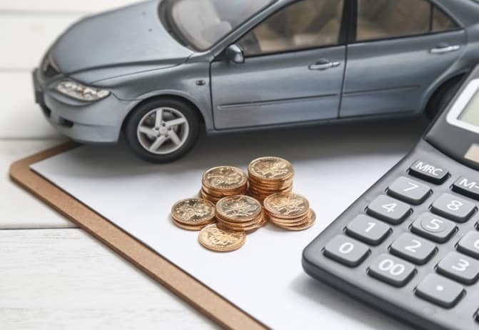 1s remote control car next to stack of coins on clipboard