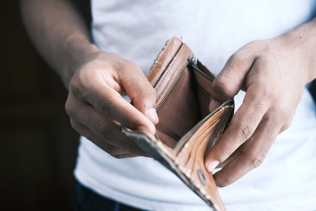 man holding open wallet empty
